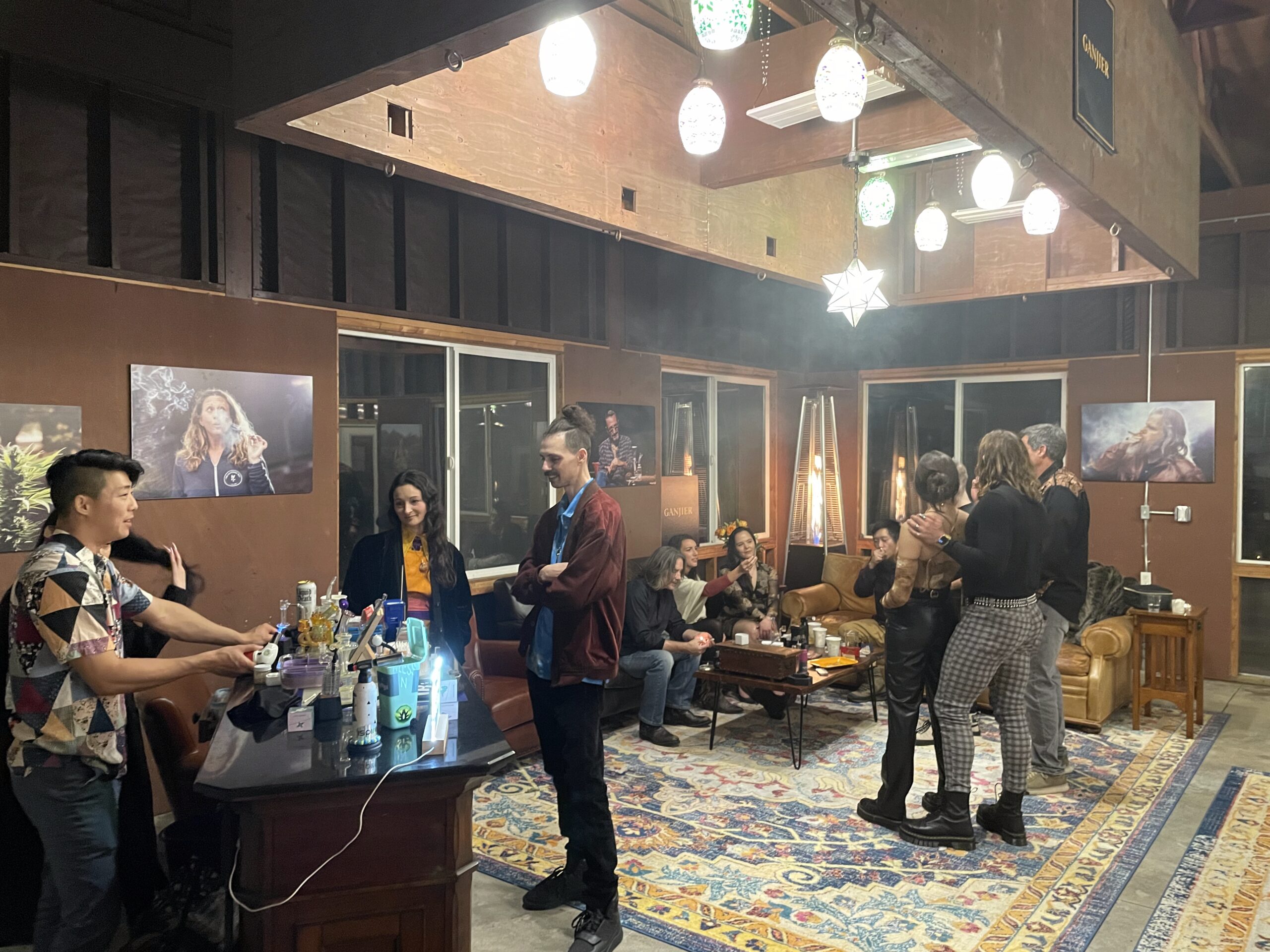 Social gathering under warm Casablanca lighting in the Dojo at Farmer and Flame cannabis retreat