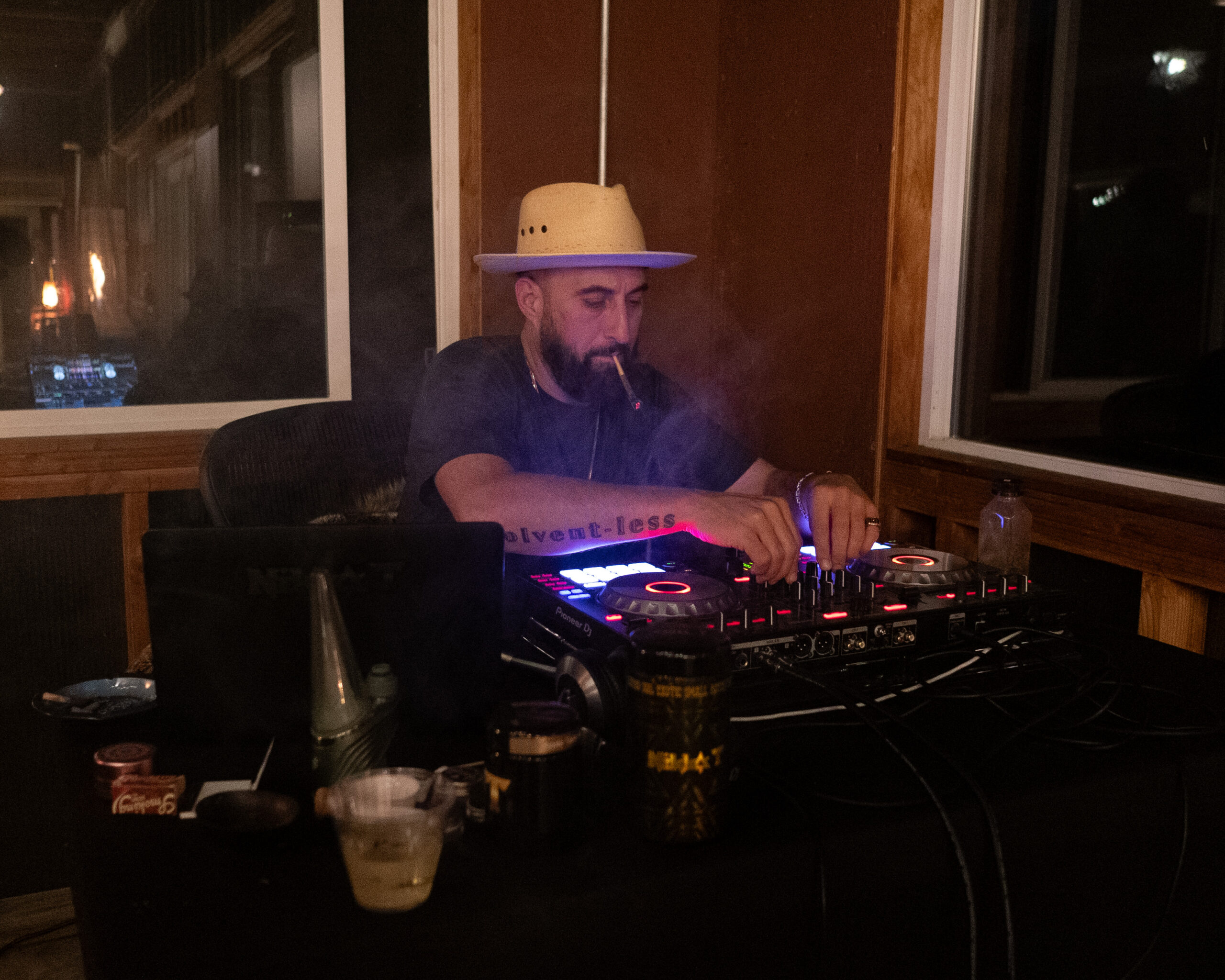 Live DJ set with smoke haze and purple lighting at Farmer and Flame retreat in Humboldt County